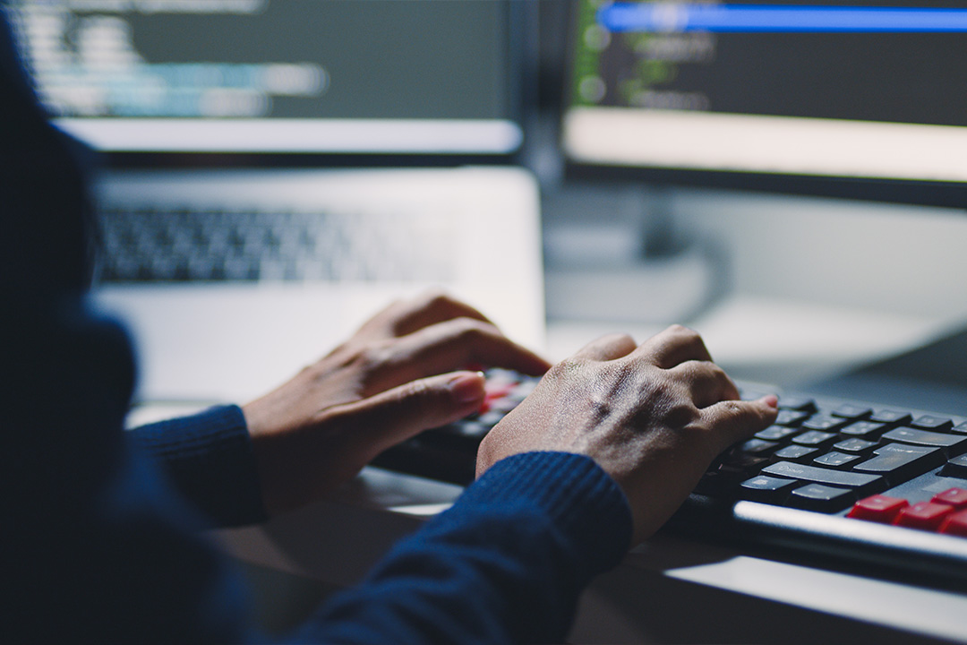 IT support agent typing at computer keyboard