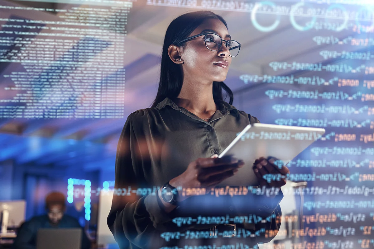 A photo of an IT security expert wearing glasses, holding a tablet, with an overlay of codes and computer screens